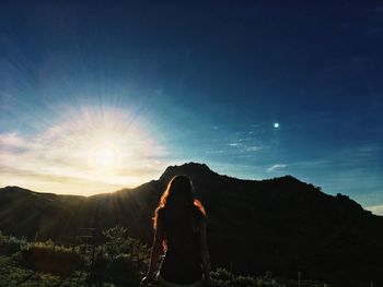 Man standing on mountain against sky