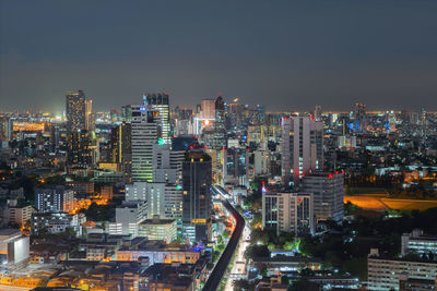 High angle view of illuminated buildings against sky at night