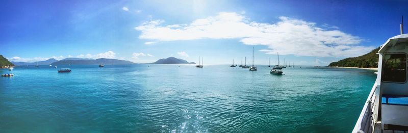 Panoramic view of boats in sea against sky