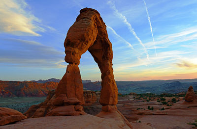 Rock formation against cloudy sky