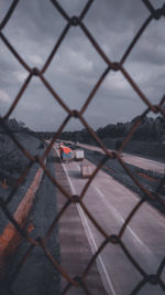 Chainlink fence against sky during winter