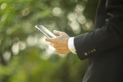 Cropped image of businessman using phone