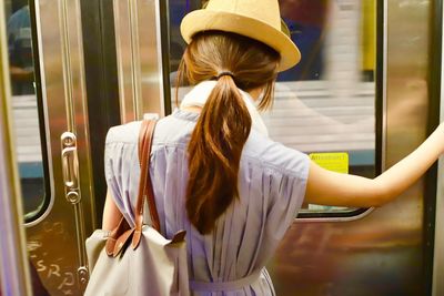 Rear view of woman in train