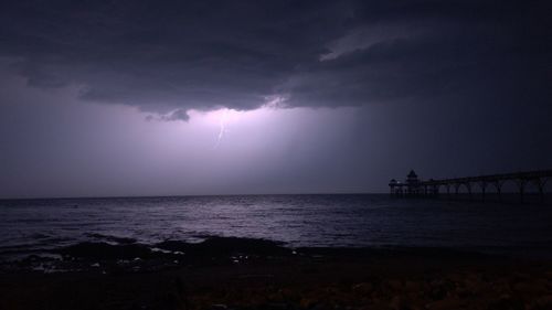 Scenic view of sea against storm clouds