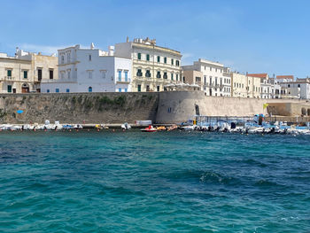 View of boats in sea against buildings