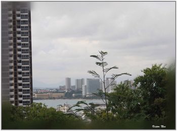 Cityscape against cloudy sky