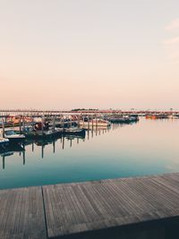 Pier over sea against clear sky during sunset