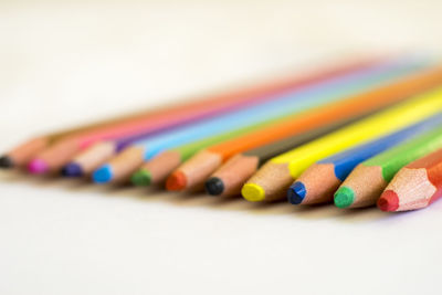 Close-up of colored pencils on white background