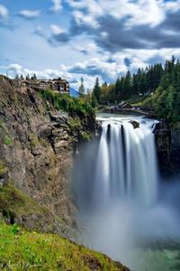 Scenic view of waterfall against sky