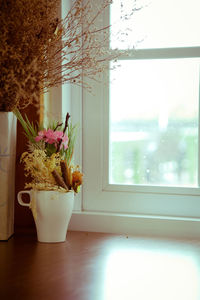 Close-up of potted plant on table by window