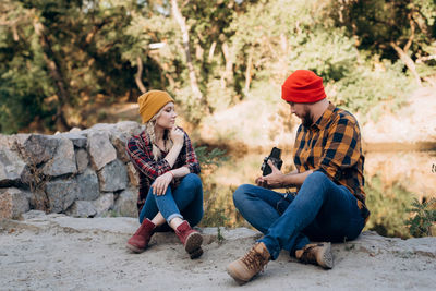 Young couple sitting outdoors