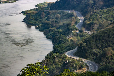 High angle view of road amidst trees and mountains