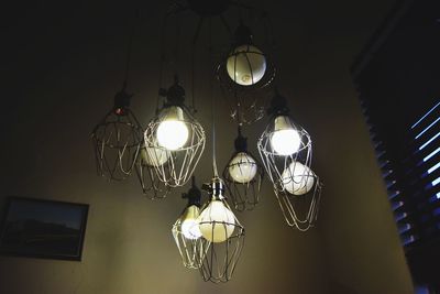 Low angle view of illuminated light bulb at home