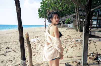 Portrait of woman standing on beach