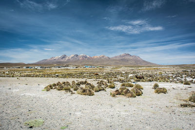 Scenic view of mountains against cloudy sky