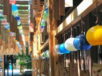 Close-up of illuminated lanterns hanging by buildings in city