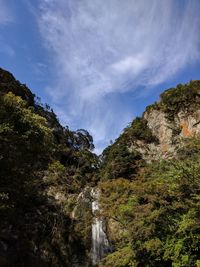 Low angle view of waterfall against sky