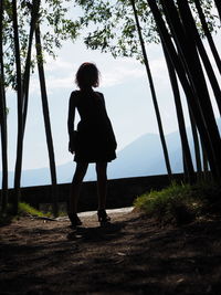 Full length of woman standing on land against sky