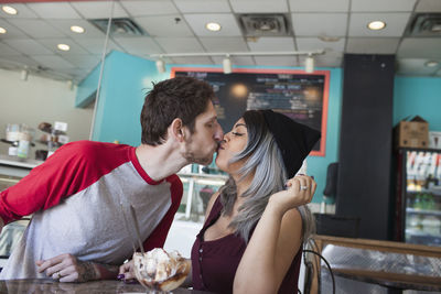 Young couple kissing at home