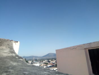 Buildings against clear blue sky