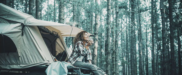 Rear view of man sitting in tent