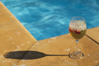 Close-up of drink by swimming pool