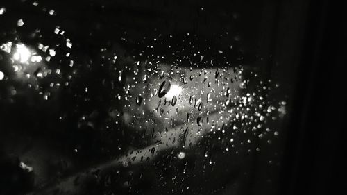 Close-up of illuminated water against sky at night