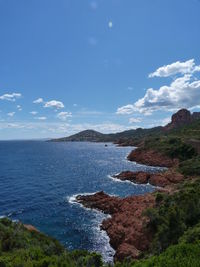 View of calm blue sea against mountain range