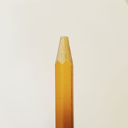 Close-up of yellow pencils against white background