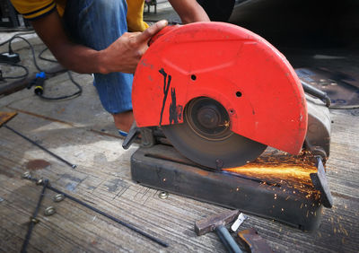 Low section of man working on wood