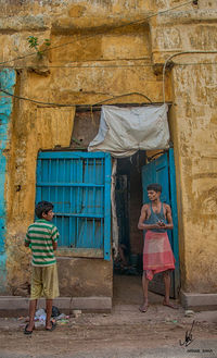 Full length of a man standing against the wall