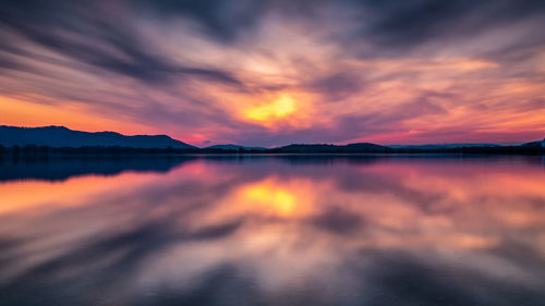 Scenic view of lake against romantic sky at sunset