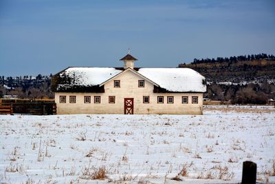 Barn on snow covered landscape