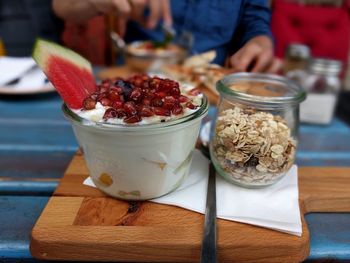 Close-up of hand with ice cream on table