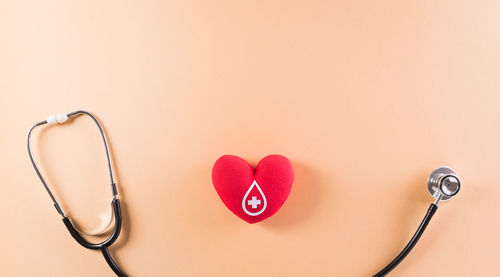 Close-up of heart shape on table against wall