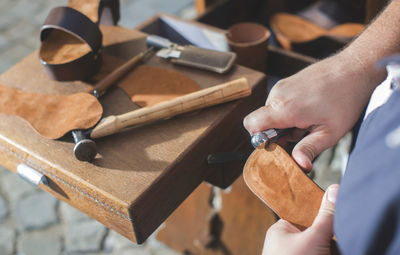 Close-up of shoemaker making sandal at workshop