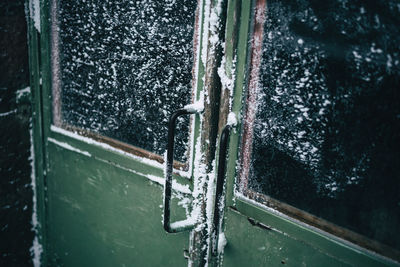 Close-up of frozen green closed door