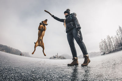 Low angle view of people on snow covered landscape