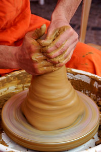 Midsection of person working in mud