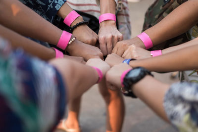 Cropped image of people clenching fists