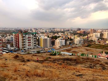 High angle view of buildings in city against sky