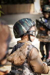 Rear view of boy looking at camera