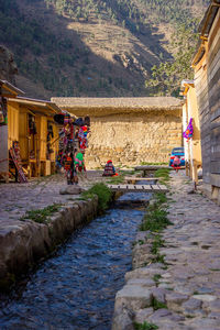 People on street amidst buildings in city