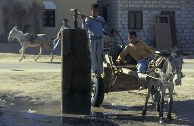 Rear view of people walking on street