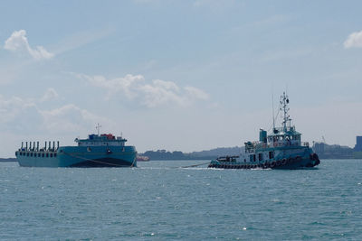 Ship sailing on sea against sky