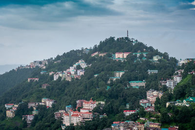 Buildings in town against sky