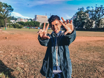 Woman photographing with mobile phone standing outdoors