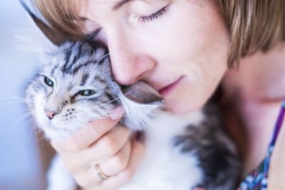 Close-up of woman with cat