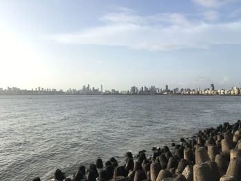 Panoramic view of sea and buildings against sky