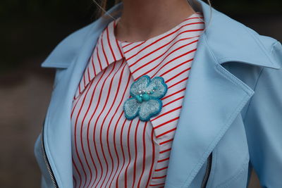 Midsection of woman with brooch